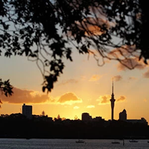 The sun sets over Auckland city