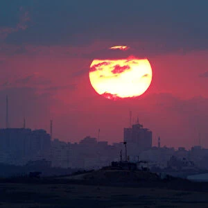 The sun sets over the Gaza Strip, as seen from the Israeli side