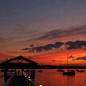 The sun sets over Manhasset Bay in Port Washington, New York