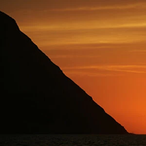 Sun sets near San Lorenzo Island as seen from Limas Port Callao