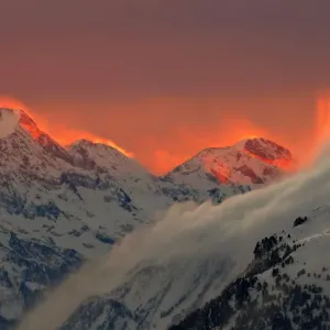 The sunset illuminates the peaks of the mountains near the Swiss mountain resort of St The sunset illuminates the peaks of the mountains near the Swiss mountain resort of St