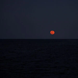 A super blood blue moon rises in central Mediterranean Sea