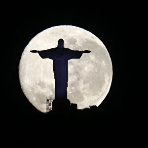 The supermoon is pictured behind the Christ the Redeemer statue in Rio de Janeiro
