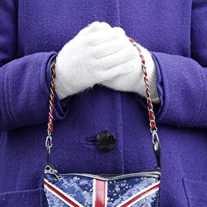 A supporter poses with Union Jack handbag and white golves