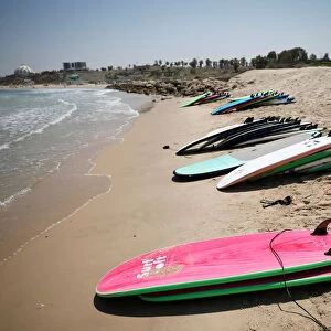 Surfing boards are seen on the beach at the Mediterranean Sea during a summer camp