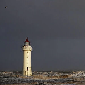 A tanker battles through heavy seas as it passes Perch Rock lighthouse on the River