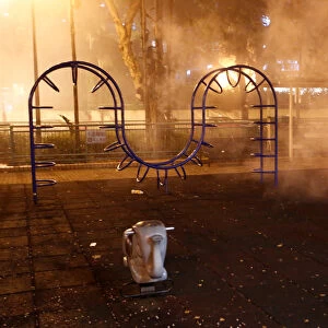 Tear gas is seen at a childrens playground outside a police station in Shatin