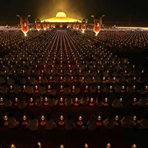 Thousands of believers join Buddhist monks praying at the Wat Phra Dhammakaya temple