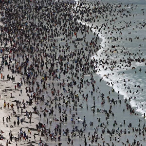 Thousands of people flock to celebrate New Years Day on Cape Towns Muizenberg beach