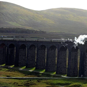 The Tornado Steam Locomotive crosses Ribblehead viaduct in northern England