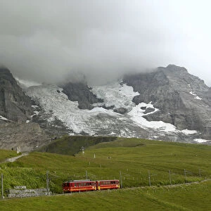 Tourists leave a train of the Jungfraubahn railways at the Kleine Scheidegg station