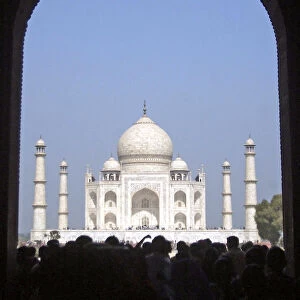 Tourists stand in front of the Taj Mahal in Agra