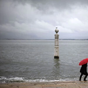 Tourists visit the Cais das Colunas in front of the Tagus River in Lisbon