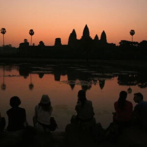 Tourists wait for the sun to rise over Angkor Wat in Siem Reap