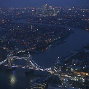 Tower Bridge and the Canary Wharf financial district are seen at dusk in an aerial