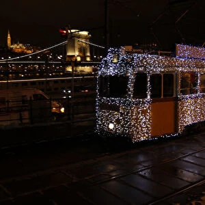 A tram decorated with Christmas lights travels in the centre of Budapest