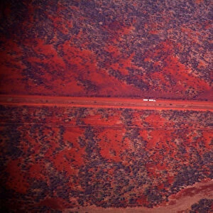 A truck drives along a road in the Pilbara region of Western Australia