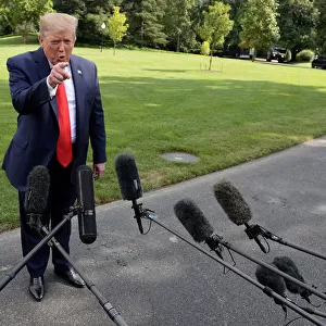 U. S. President Donald Trump speaks to the media before departing the White House