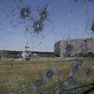 A Ukrainian border post is seen through bullet holes in a trucks windscreen on the