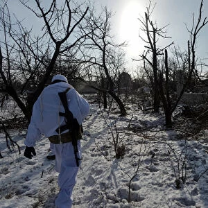 A Ukrainian serviceman walks at a position on the front line near Avdiyivka