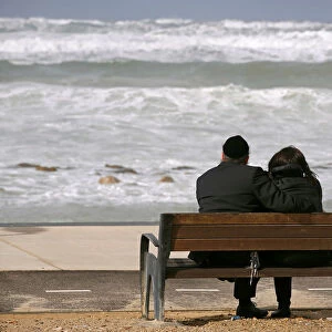 An ultra-Orthodox couple watches the sea during a storm in the Mediterranean coast of the