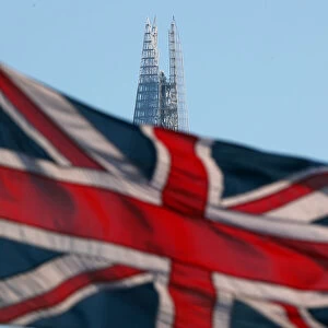 A Union Flag flies in front of the Shard skyscraper in London