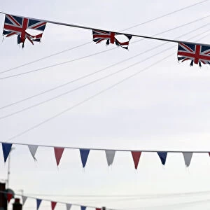 Union flags and coloured bunting hang above a street in South Belfast