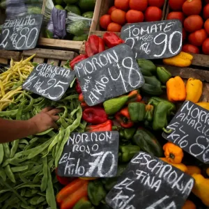 A vegetable seller grabs a handful of indian beans at a street market, in Buenos Aires A vegetable seller grabs a handful of indian beans at a street market, in Buenos Aires