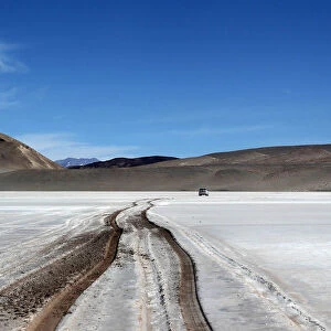 Vehicle tracks are seen on the surface of the salt flat at Olaroz
