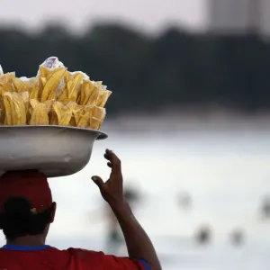 A vendor sells Amazon food next to the Negro River in Manaus A vendor sells Amazon food next to the Negro River in Manaus