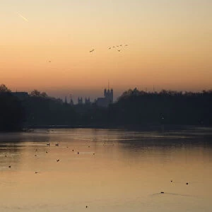 A view of the Houses of Parliament at sunrise from the Serpentine lake in Hyde Park