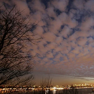 A view of storm clouds above New York City and the Hudson River at sunset