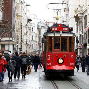 A vintage tram runs along the main shopping and pedestrian street of Istiklal in central
