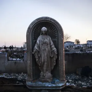 A Virgin Mary statue is seen amongst the rubble of a destroyed row of houses after A Virgin Mary statue is seen amongst the rubble of a destroyed row of houses after