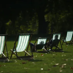 Visitors enjoy the autumn sunshine as they sit in deck chairs in St James Park, central Visitors enjoy the autumn sunshine as they sit in deck chairs in St James Park, central