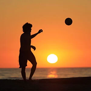 Volleyball players change serve as the sun sets at Moonlight Beach in Encinitas