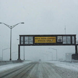 A warning alert is seen on a display as cars drive along the New Jersey Turnpike during a