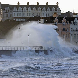 Waves crash against the sea wall in the town of Portrush, as storms hit the United