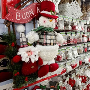 A woman looks at Christmas decorations in a shop in Rome