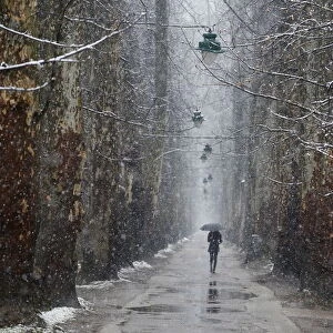 A woman walks during heavy snowfall in Sarajevo