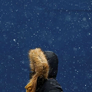 A woman walks in the snow at Times Square in New York
