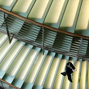 A worker at a hotel walks down a staircase in Tokyo