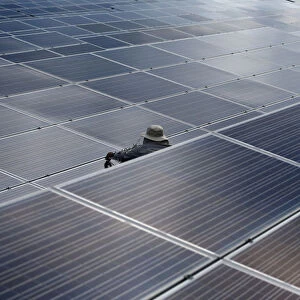 A worker works at a solar power plant by Superblock, Southeast Asias biggest producer of