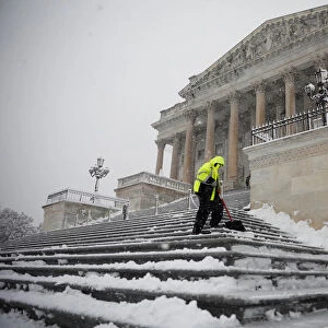 Workers clear the steps of the House of Representatives on Capitol Hill in Washington