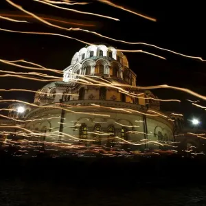 Worshippers walk with candles around the golden-domed Alexander Nevski cathedral during Worshippers walk with candles around the golden-domed Alexander Nevski cathedral during