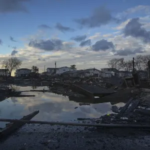 The wreckage of homes devastated by fire and the effects of Hurricane Sandy are seen in The wreckage of homes devastated by fire and the effects of Hurricane Sandy are seen in