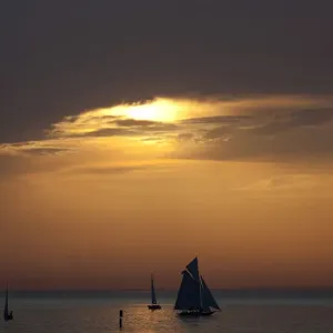 Yachts are silhouetted as sun sets over Lake Constance in Bregenz Yachts are silhouetted as sun sets over Lake Constance in Bregenz