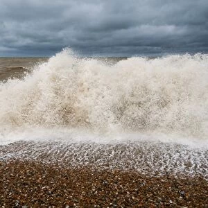 Waves crashing against shoreline of shingle beach, Dungeness, Kent, England, June