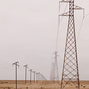Africa, Namibia, Swakopmund. View of power and telephone lines in Namib Desert. Credit as