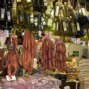 Cured meats, sausages, and olive oil being sold at the Mercado Municipal in Sao Paulo, Brazil
